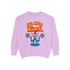 A Christmas sweatshirt featuring a playful design with a cartoon Baphomet goat character wearing a Santa hat. The design includes the text "All Hail Santa" above the goat, with pentagrams in flames on either side. The goat is depicted in a meditative pose, adding a humorous and irreverent twist to holiday attire.